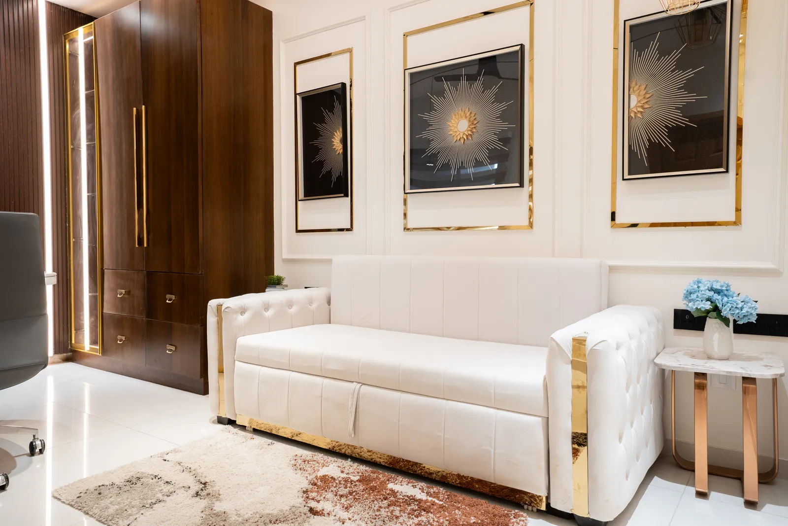 Lounge with tufted cream sofa, starburst art and walnut wardrobe — Abhishek's Residence